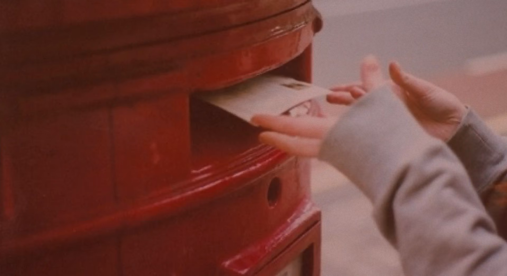 Postbox with a letter being posted